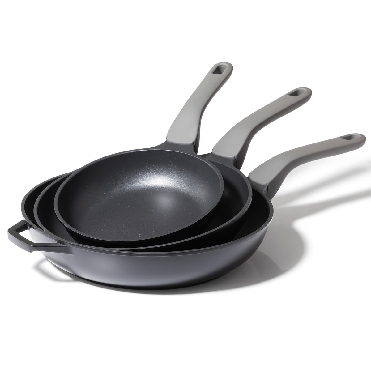 Black three frying pans stacked.