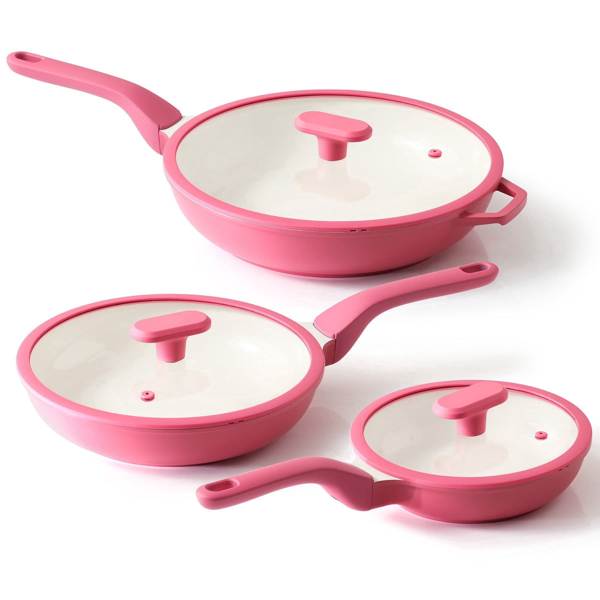 Three pink frying pans in different sizes with matching lids.